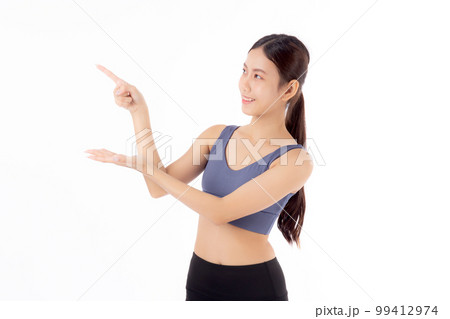 Portrait of beautiful young asian woman in sportwear smile and presenting isolated  99412974