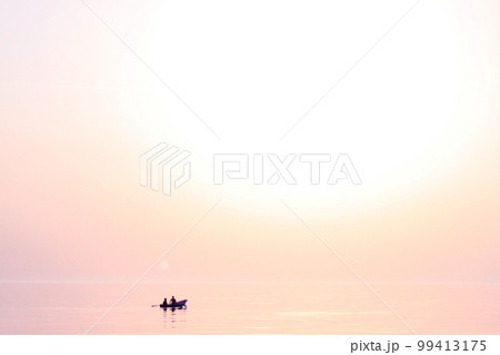 Sunset at sea. Romantic photo with the sea rolling in the sky and the couple in love in a boat. Pink sunset, big sun, bright lights, waves, black silhouette of people in a boat. Copy space Sunset at sea. Romantic photo with the sea rolling in the sky and the couple in love in a boat. Pink sunset, big sun, bright lights, waves, black silhouette of people in a boat. Copy space 99413175