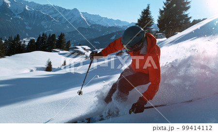 Freeride skier riding in the scenic mountains with blue sky Freeride skier riding in the scenic mountains with blue sky 99414112