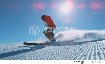 Freeride skier riding in the scenic mountains with blue sky Freeride skier riding in the scenic mountains with blue sky 99414115