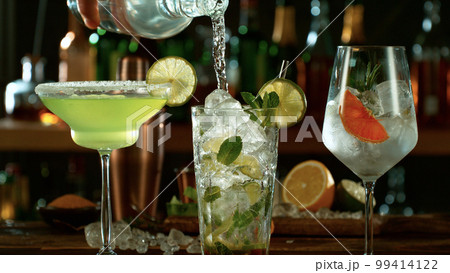 Fresh various cocktails on the bar, dark toned background 99414122