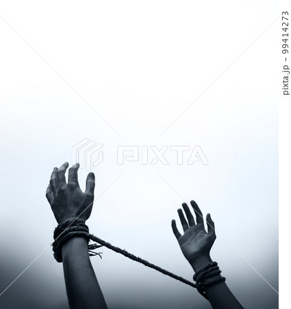 Tied hands raised to the sky 99414273
