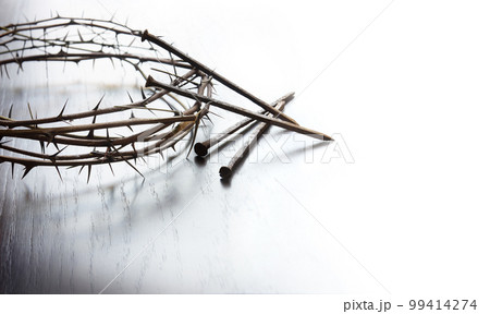 Rusty nails and a wreath of thorns at the cross 99414274