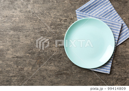 Top view on colored background empty round green plate on tablecloth for food. Empty dish on napkin with space for your design Top view on colored background empty round green plate on tablecloth for food. Empty dish on napkin with space for your design 99414809