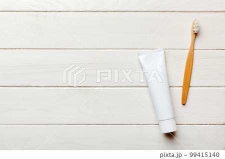 toothpaste and toothbrush top view with copy space on colored background. Flat lay. Dental hygiene. Oral care products on light background. Body care concept toothpaste and toothbrush top view with copy space on colored background. Flat lay. Dental hygiene. Oral care products on light background. Body care concept 99415140