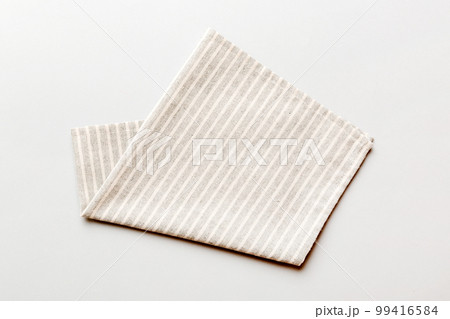 top view with gray kitchen napkin isolated on table background. Folded cloth for mockup with copy space, Flat lay. Minimal style top view with gray kitchen napkin isolated on table background. Folded cloth for mockup with copy space, Flat lay. Minimal style 99416584