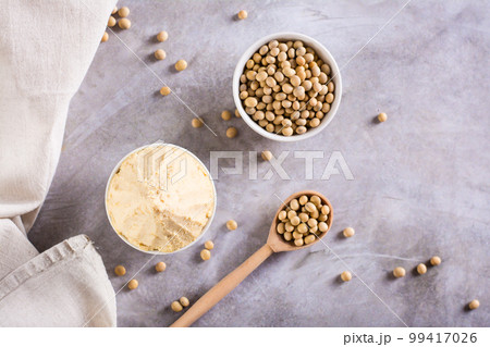 Japanese seasoning miso fermented from soy and koji rice in a bowl on the table. Top view Japanese seasoning miso fermented from soy and koji rice in a bowl on the table. Top view 99417026