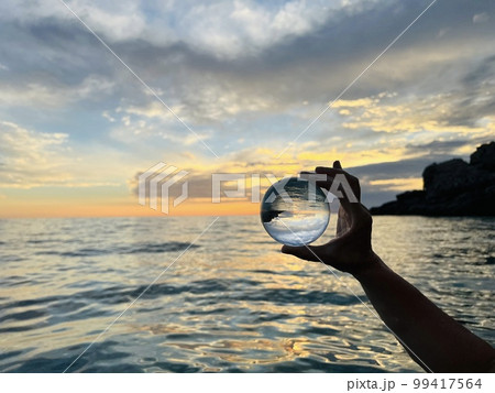 Beautiful scenic view through lens of crystal ball at summer sunset. Beautiful scenic view through lens of crystal ball at summer sunset. 99417564
