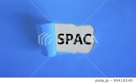 SPAC, special purpose acquisition company symbol. Words 'SPAC' appearing behind torn blue paper. Beautiful blue background, copy space. Business and SPAC, special purpose acquisition company concept. 99418540