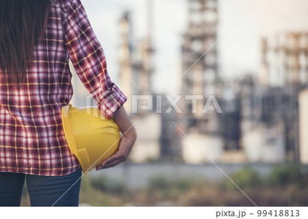 Woman worker hands holding hardhat yellow work helmet Construction Engineer. Refinery woman worker oil petro industry hand hold yellow worker helmet hard hat. Refinery industry engineer manufacture Woman worker hands holding hardhat yellow work helmet Construction Engineer. Refinery woman worker oil petro industry hand hold yellow worker helmet hard hat. Refinery industry engineer manufacture 99418813