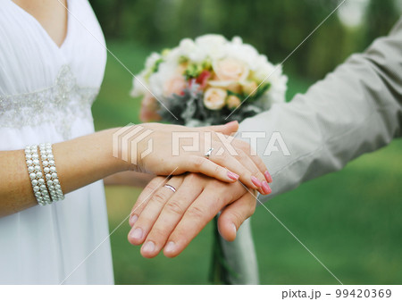 Palms of husband and wife, newlywed. Wedding ring on your finger. Valentine's day Palms of husband and wife, newlywed. Wedding ring on your finger. Valentine's day 99420369