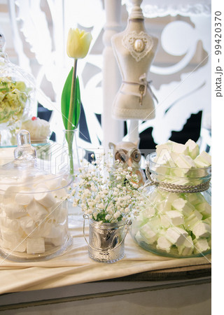 Wedding candy bar with white flowers in rustic style 99420370