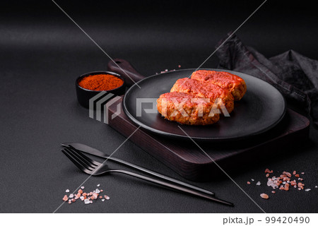 Meat cutlet or meatballs in tomato sauce with garlic, salt, spices and herbs Meat cutlet or meatballs in tomato sauce with garlic, salt, spices and herbs 99420490