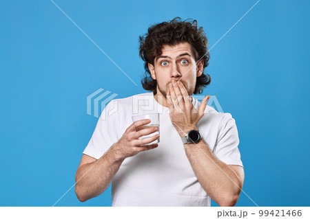 handsome man with drinking glass of water handsome man with drinking glass of water 99421466