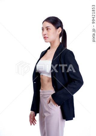 Smiling asiean woman showing abdominal muscles and wearing suit poses in white background.  99421853