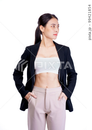Smiling asiean woman showing abdominal muscles and wearing suit poses in white background. Smiling asiean woman showing abdominal muscles and wearing suit poses in white background. 99421854
