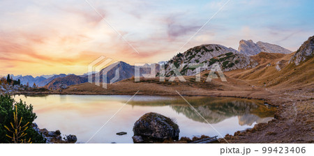Early morning autumn alpine Dolomites mountain scene. Peaceful Valparola Pass and Lake view, Belluno, Italy. Early morning autumn alpine Dolomites mountain scene. Peaceful Valparola Pass and Lake view, Belluno, Italy. 99423406
