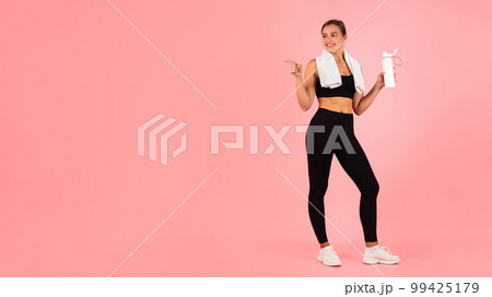 Fitness Offer. Young Athletic Female In Sportswear Pointing Aside At Copy Space Fitness Offer. Young Athletic Female In Sportswear Pointing Aside At Copy Space 99425179