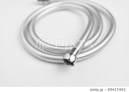 New flexible rubber shower hose on a white background. New flexible rubber shower hose on a white background. 99425902