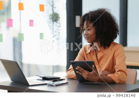 Accountant black woman working on laptop and do document, tax, exchange, accounting and Financial advisor concept 99428140