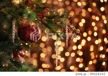 A branch of a Christmas tree decorated with New Year A branch of a Christmas tree decorated with New Year 99428142