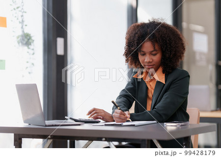 Accountant black woman working on laptop and do document, tax, exchange, accounting and Financial advisor concept Accountant black woman working on laptop and do document, tax, exchange, accounting and Financial advisor concept 99428179