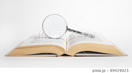 Open book with magnifying glass. Data search, research conducting concept. High quality photo 99429023