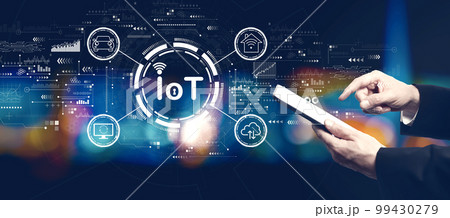 IoT theme with businessman using a tablet computer IoT theme with businessman using a tablet computer 99430279