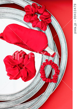 top view red accessories sleeping mask on grey background top view red accessories sleeping mask on grey background 99433479