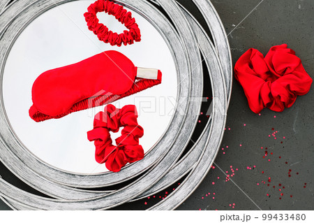 top view red accessories sleeping mask on grey background top view red accessories sleeping mask on grey background 99433480