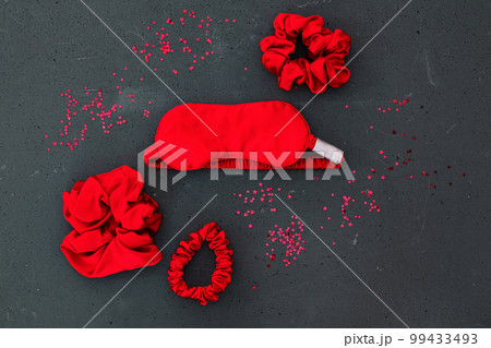 top view red accessories sleeping mask on grey background top view red accessories sleeping mask on grey background 99433493