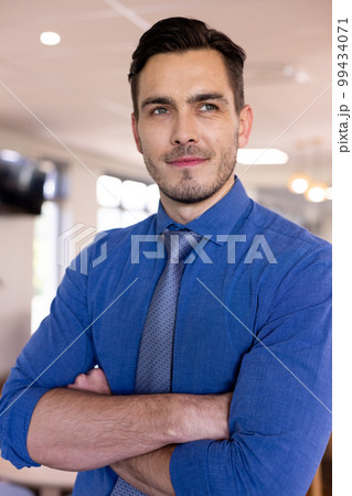 Happy caucasian businessman wearing blue shirt in modern office 99434071