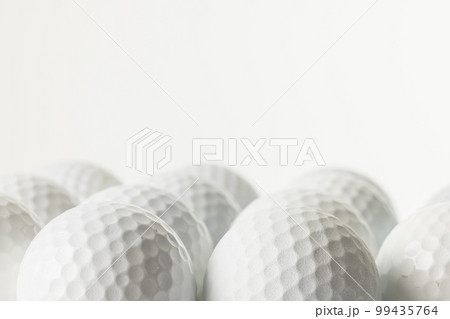 Close up of white golf balls with copy space on white background Close up of white golf balls with copy space on white background 99435764