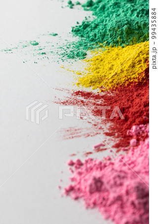 Close up of multi coloured powder and copy space on white background Close up of multi coloured powder and copy space on white background 99435884
