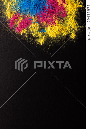 Close up of multi coloured powder and copy space on black background Close up of multi coloured powder and copy space on black background 99435975