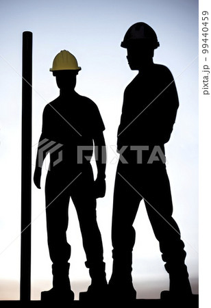 silhouette of worker at the construction site at sunset silhouette of worker at the construction site at sunset 99440459