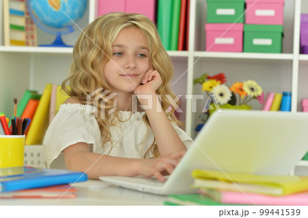 girl using laptop at desk at home girl using laptop at desk at home 99441539