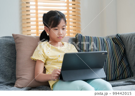 Asian little girl happy smile using tablet. Asian little girl happy smile using tablet. 99442015