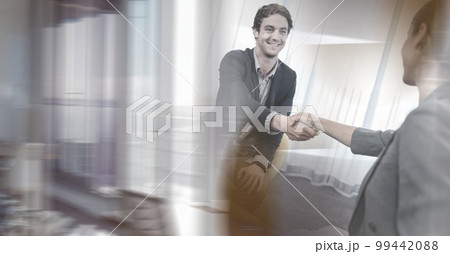 Composition of two happy diverse businesspeople shaking hands with motion blur Composition of two happy diverse businesspeople shaking hands with motion blur 99442088