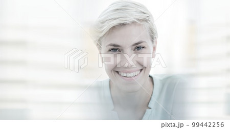 Composition of happy caucasian busineswoman looking at camera and smiling with double exposure 99442256