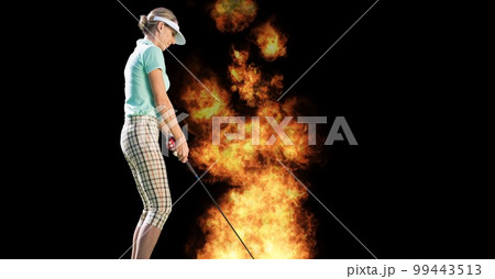 Composition of female golf player over flames on black background Composition of female golf player over flames on black background 99443513