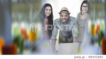 Composition of happy diverse business team using laptop with double exposure 99443885
