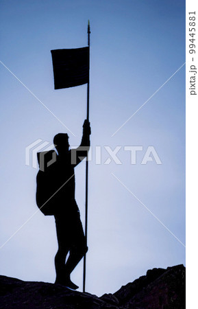 silhouette of man climbing to the top 99445881