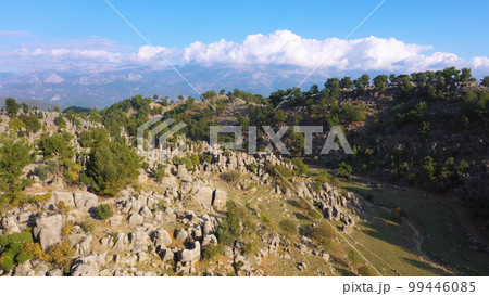 Amazing mountain landscape with picturesque rock formations on a summer day. Aerial view from drone. Amazing mountain landscape with picturesque rock formations on a summer day. Aerial view from drone. 99446085