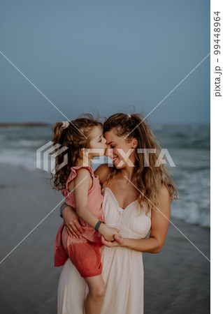 Mother enjoying together time with her daughter at sea. 99448964