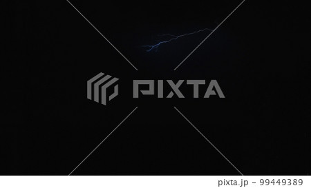Lightning in the night sky over the city, a bright flash in the clouds during a thunderstorm. Lightning in the night sky. 99449389