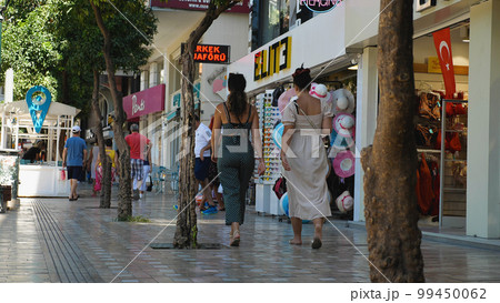 People walk along a popular pedestrian shopping street in the centre of Antalya. Antalya's old town is a popular destination for tourists 99450062