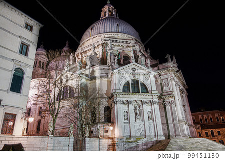 Venice Italy night view of Saint Mary of Health, Basilica di Santa Maria della Salute with cupola at Dorsoduro area. Venice Italy night view of Saint Mary of Health, Basilica di Santa Maria della Salute with cupola at Dorsoduro area. 99451130