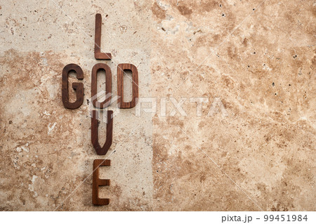 God is love concept text lying on the rustic travertine stone background. 99451984