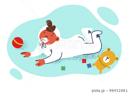 Newborn baby with pacifier in mouth crawls on floor among children toys and dangles legs 99452061